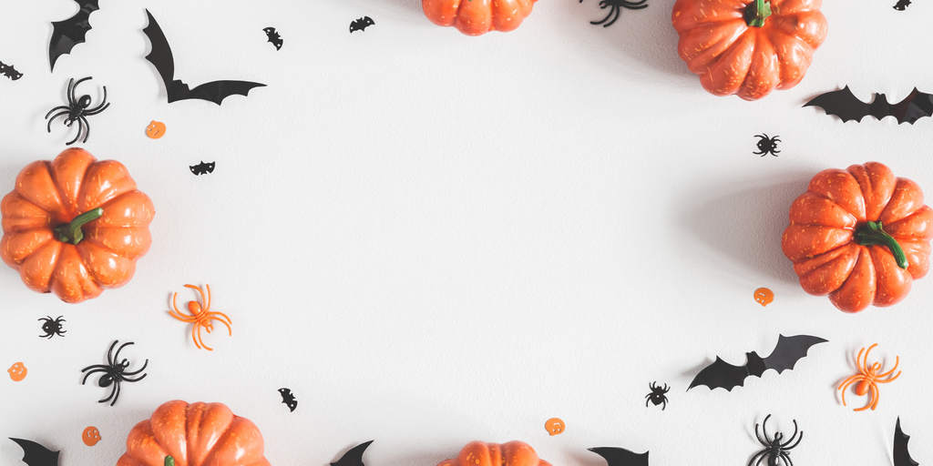 Halloween-themed decorations with pumpkins, spiders, and bats on a white background
